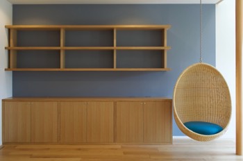 Bookshelves and storage furniture with hanging chair.   Bookshelves and storage furniture with hanging chair.